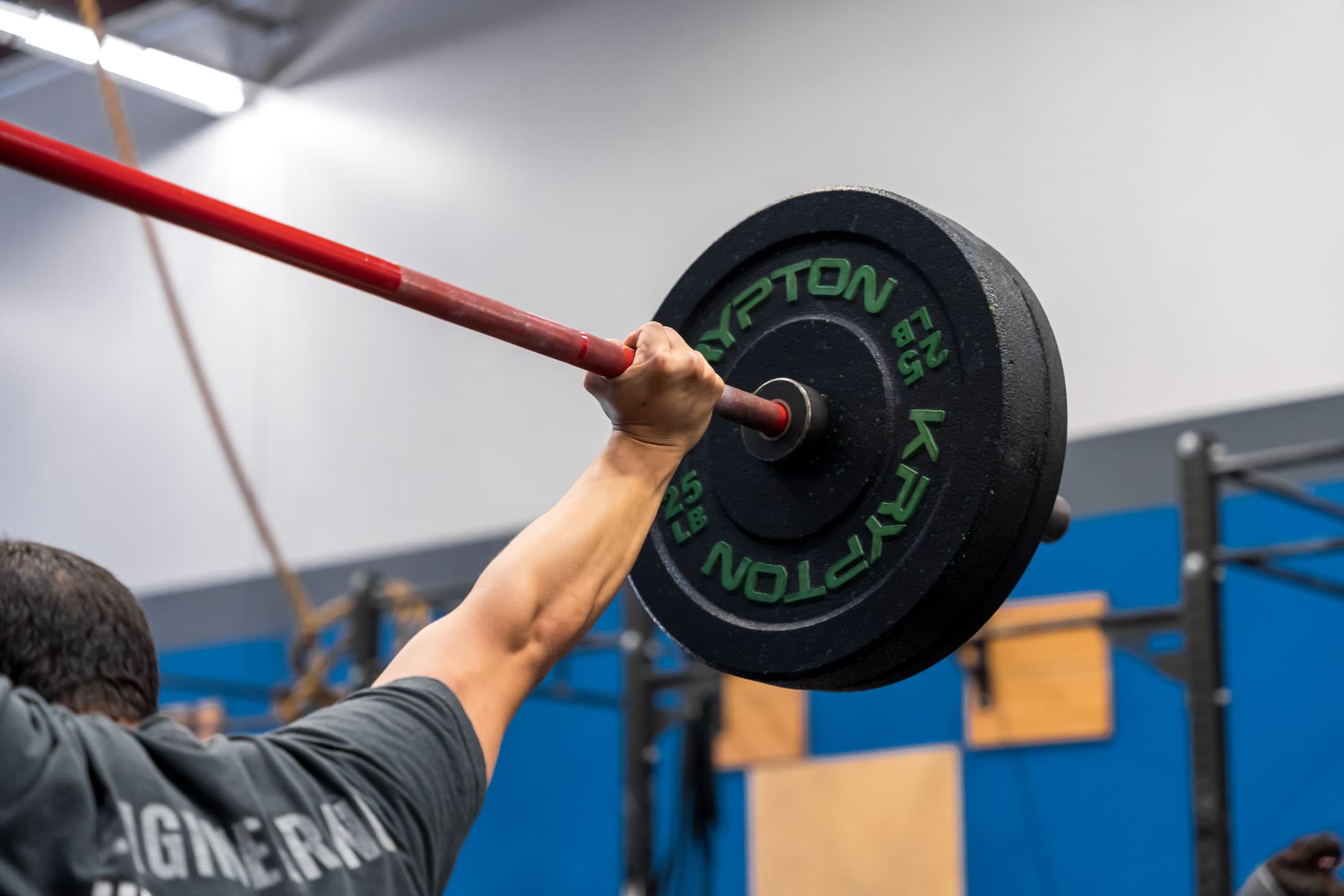 Close-up of an athlete gripping a barbell during an overhead lift at Overdrive Athletic Club in Richmond, BC