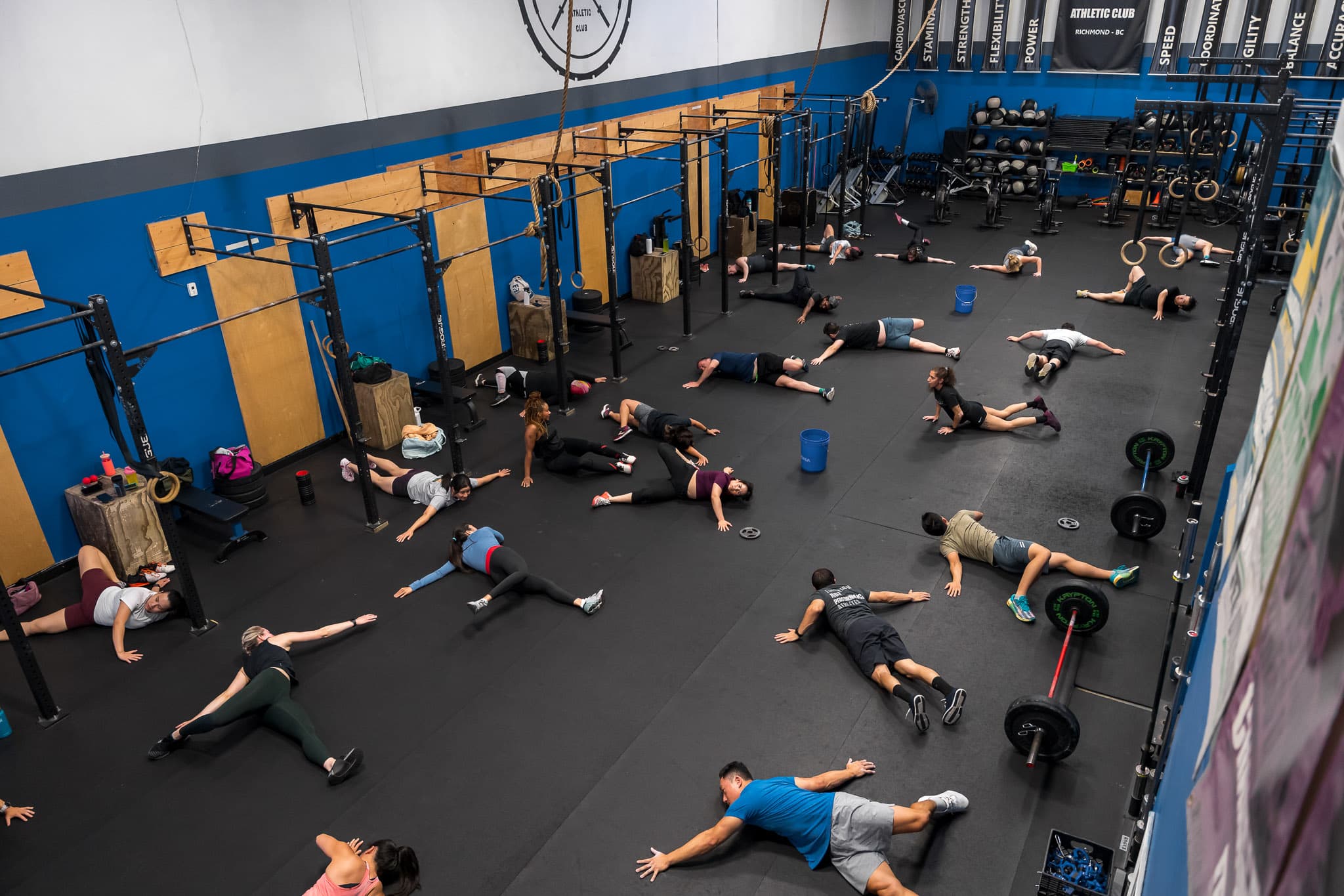An overhead view of a class stretching and doing mobility work on the floor at Overdrive Athletic Club in Richmond, BC